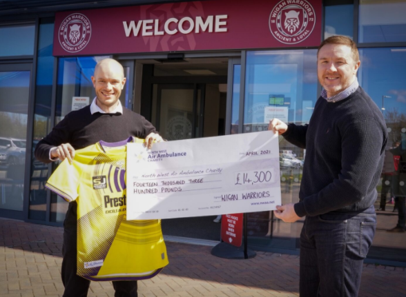 wigan warriors presenting a cheque to the north west air ambulance charity