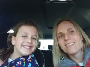 Mum and daughter smiling in car