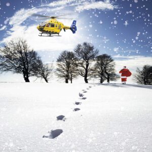 Image of Santa walking through the snow with a helicopter above.