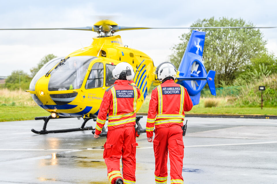 Two crew walking towards the helicopter