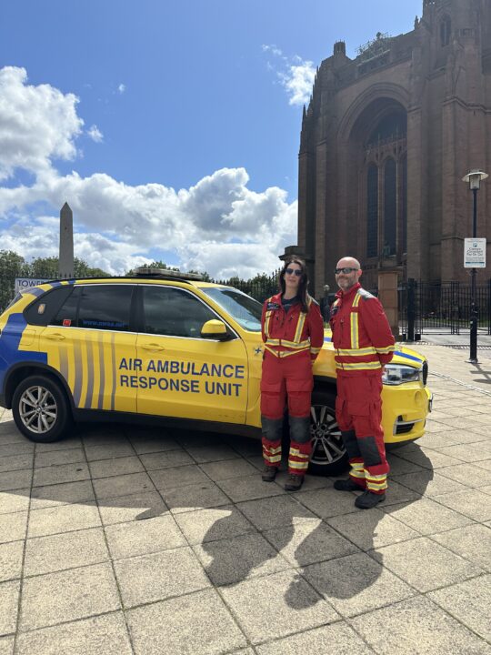 Crew stood next to the rapid response vehicle in front of the Liverpool Cathedral