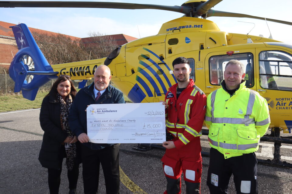 (L-R) Sue Tolley and Cllr Neal Brookes from Blackpool Council hand over handover the cheque to Captain David Wilson HEMS Pilot and Piers Peberdy HEMS Critical Care Paramedic North West Air Ambulance Charity