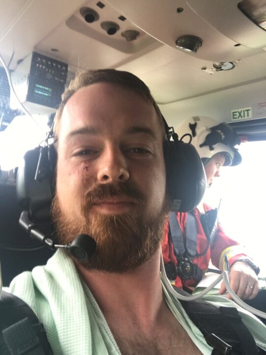 Daniel McLoughin in a helicopter following treatment