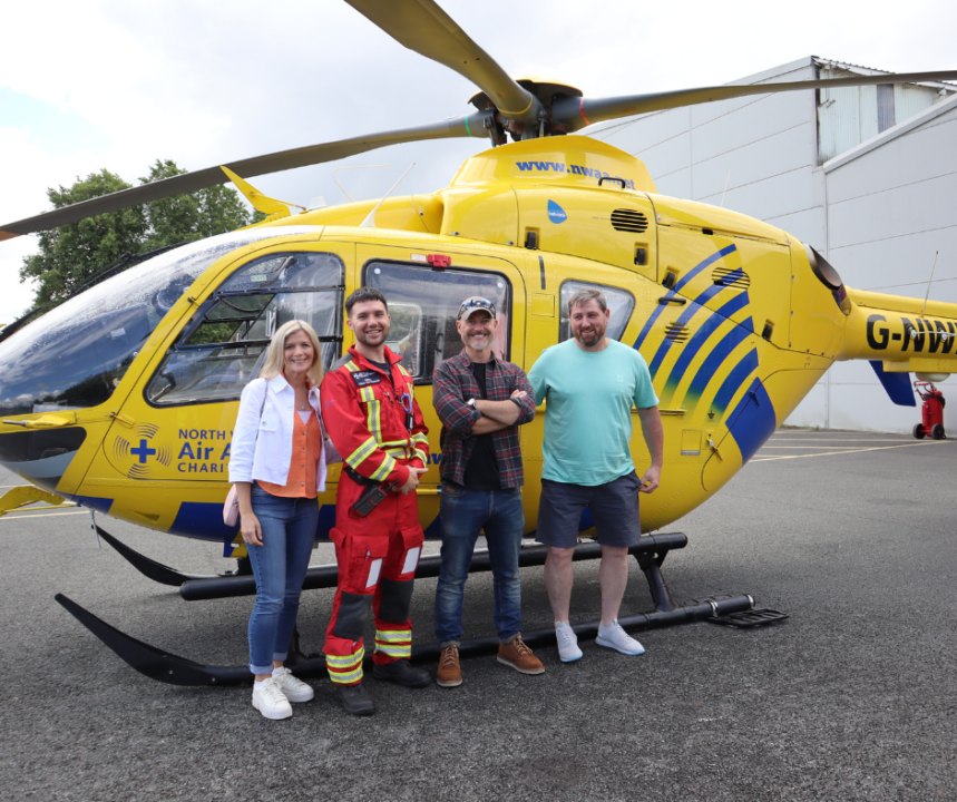 Rob, Jane, Chris and NWAA paramedic in front of a helicopter