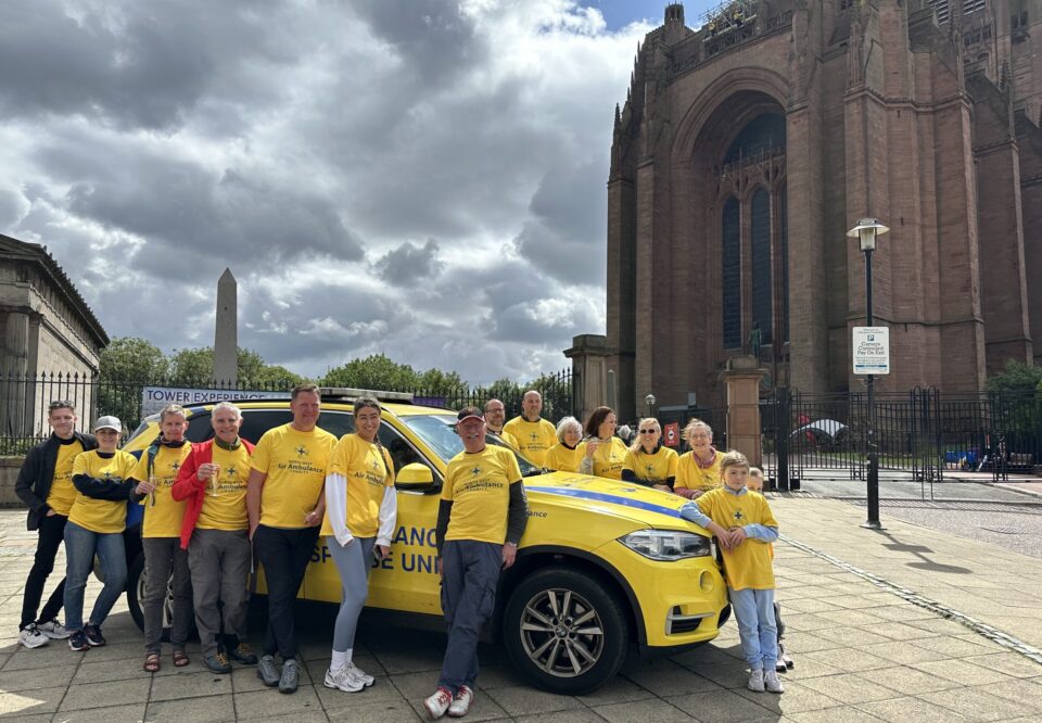NWAA Charity team in front of the critical care vehicle and Liverpool Cathedral