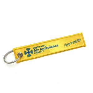 Circular metal keyring with embroidered yellow material fob with Air Ambulance logo.