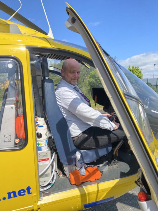 360 Loyalty Managing Director sat in the pilots seat of the Helicopter